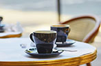 Two espresso cups on a table.