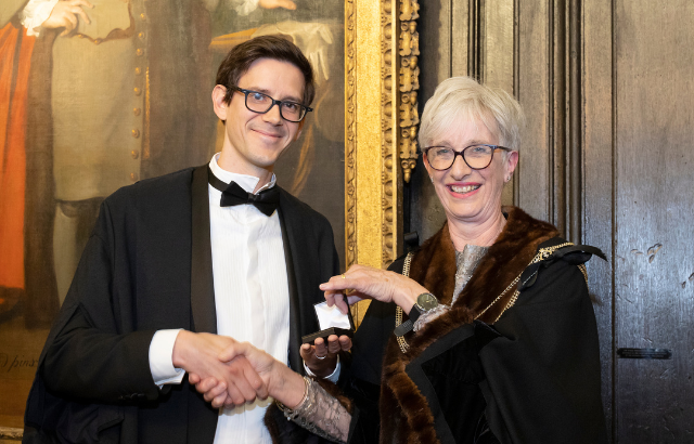 Paul Vulliamy receiving the Apothecaries' Prize from master of the society Professor Jane Anderson