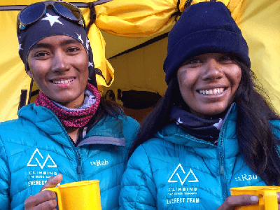 Aditi and her sister smiling at the camera, at Mount Everest base camp