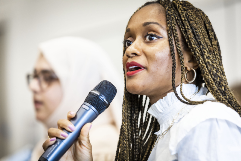 A woman speaking into a microphone