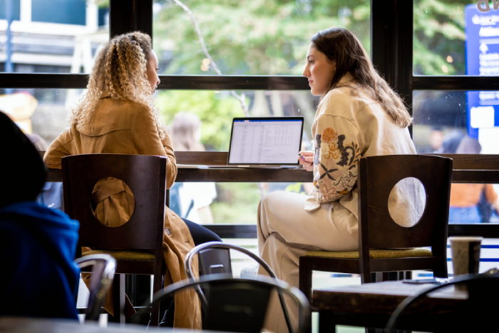 A student and mentor having coffee together