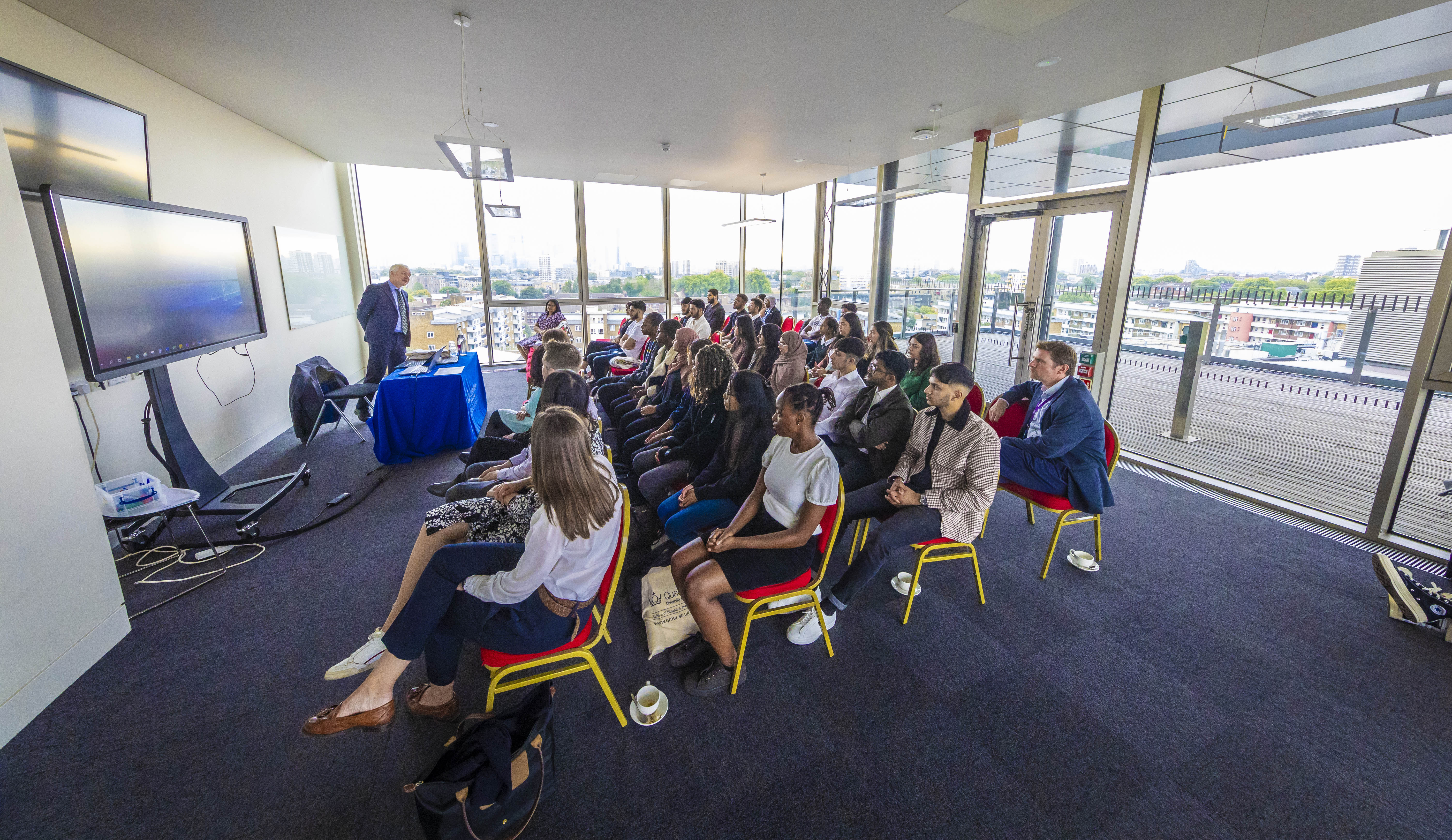 Flying Start students during their induction, sat listening to the Dean of the school, Mike Noon.