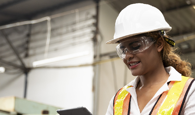 A woman of colour construction worker in construction uniform