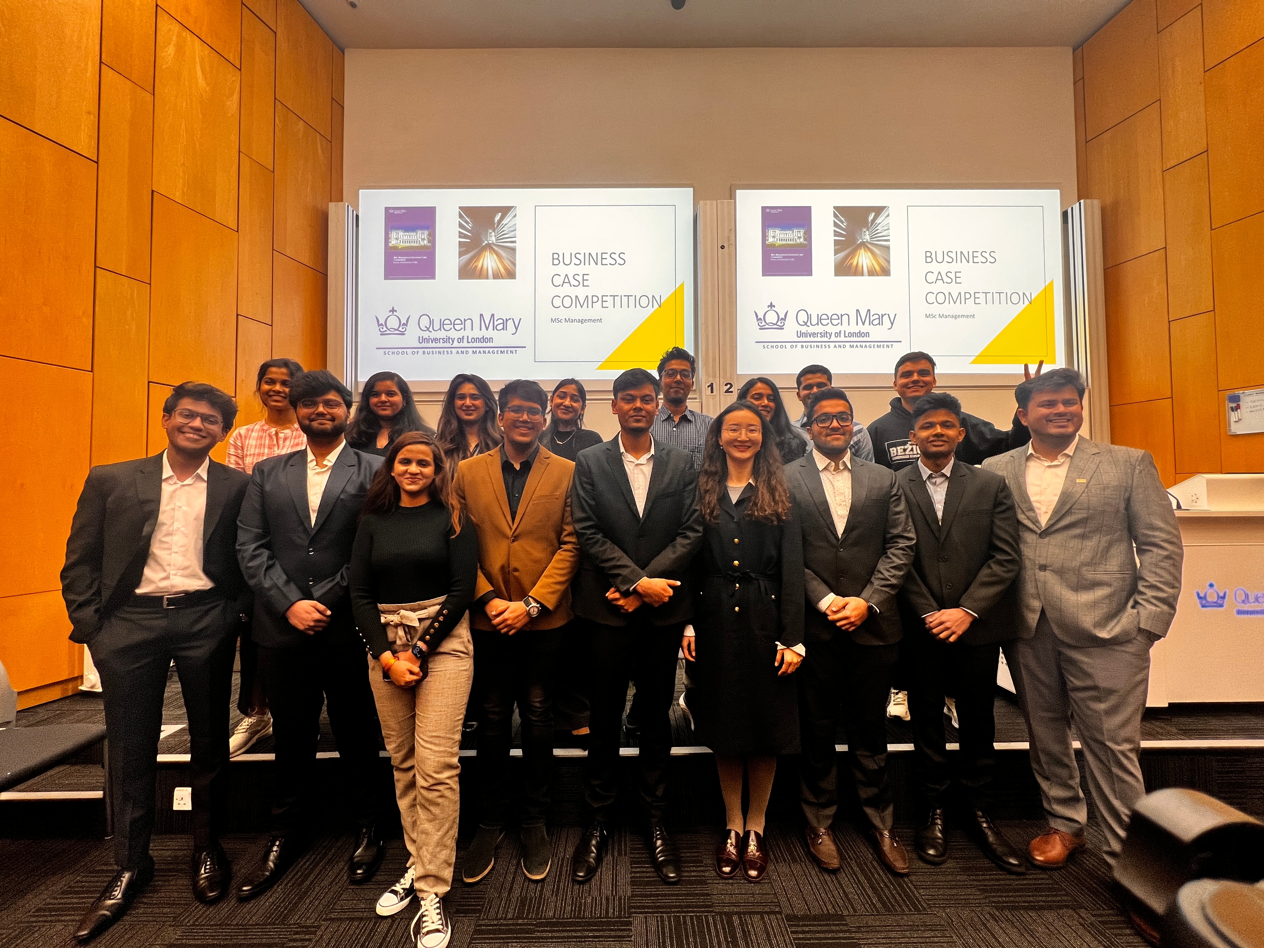 A group of winners and staff smiling at the camera.