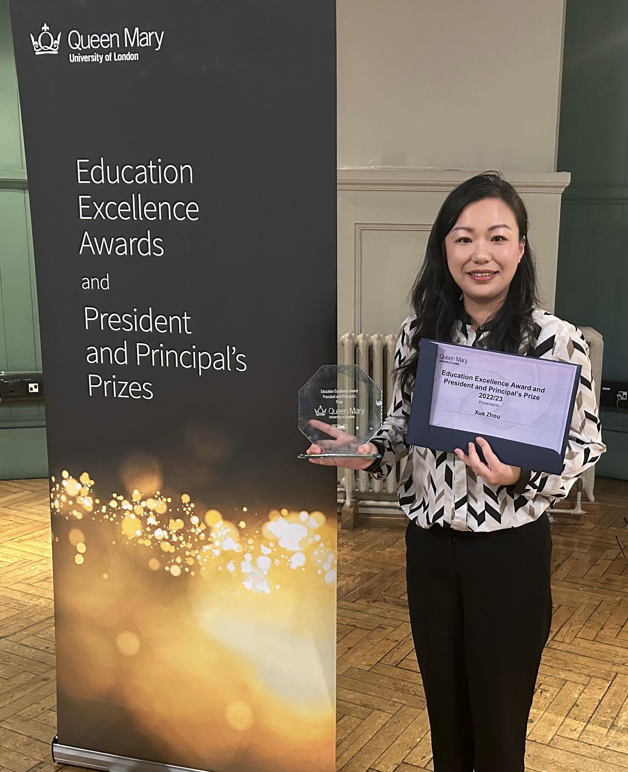 Xue Zhou holding her award