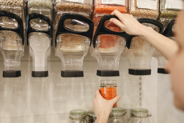 Someone using a zero waste shop to buy lentils