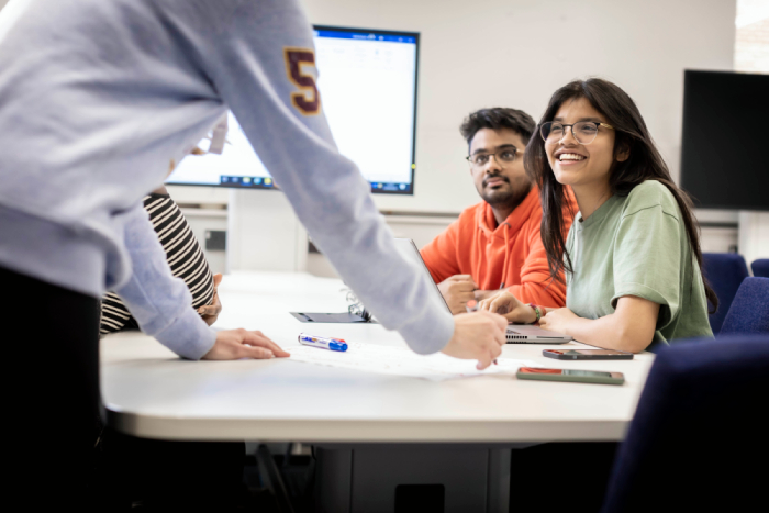 Students studying and smiling