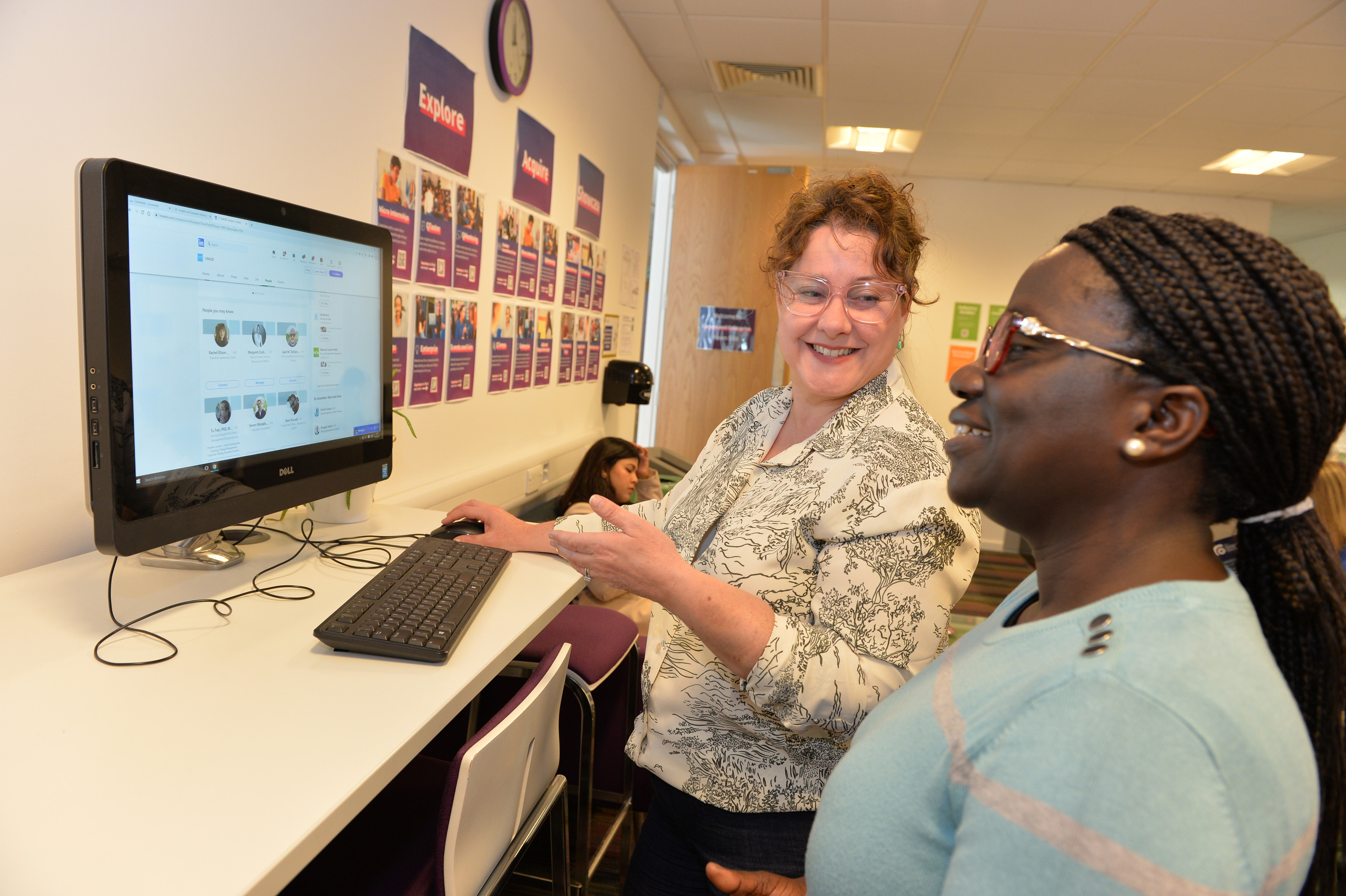 A Careers Consultant showing a student how to use LinkedIn