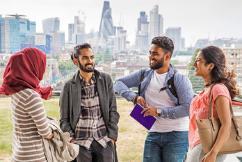 Students at top of grad centre with city backdrop