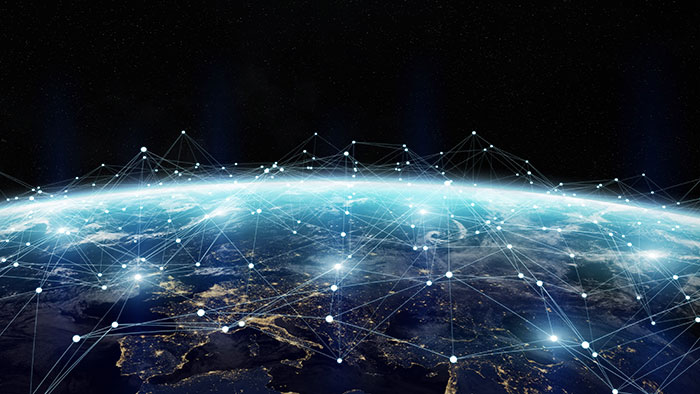 A view of the earth from space with lots interconnected dots marking various locations on the surface.