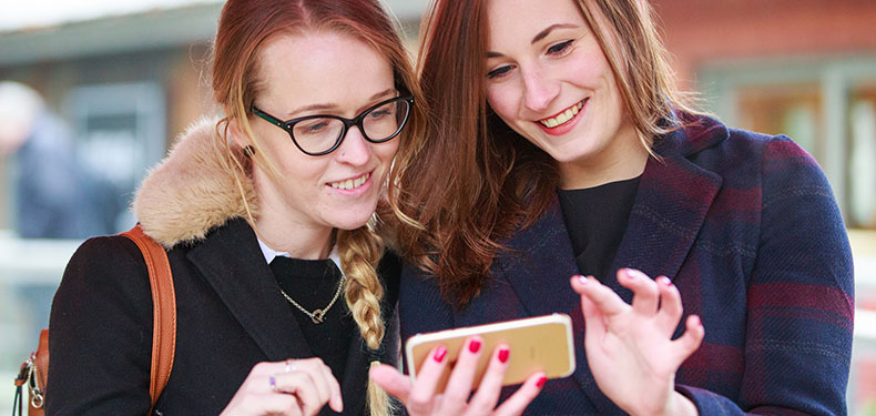 Students looking at a phone