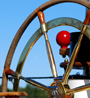 Ship wheel against a blue sky