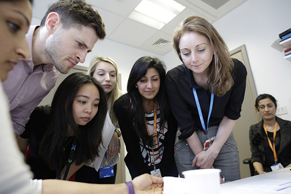 A group of students looking over some data