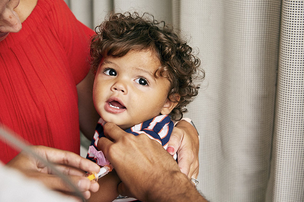 Toddler receiving a vaccine in his arm