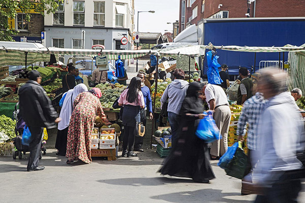 Photograph showing people shopping and walking at Whitechapel Market