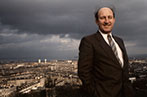 Neil MacCormick with a city skyline behind him