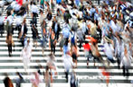 A motion blur images of pedestrians walking across a crossing in Osaka, Japan.