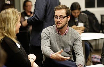 Francesco Dionisio speaking to someone at an event