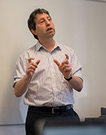 Ken Shadlen giving a lecture. He is wearing a white shirt.