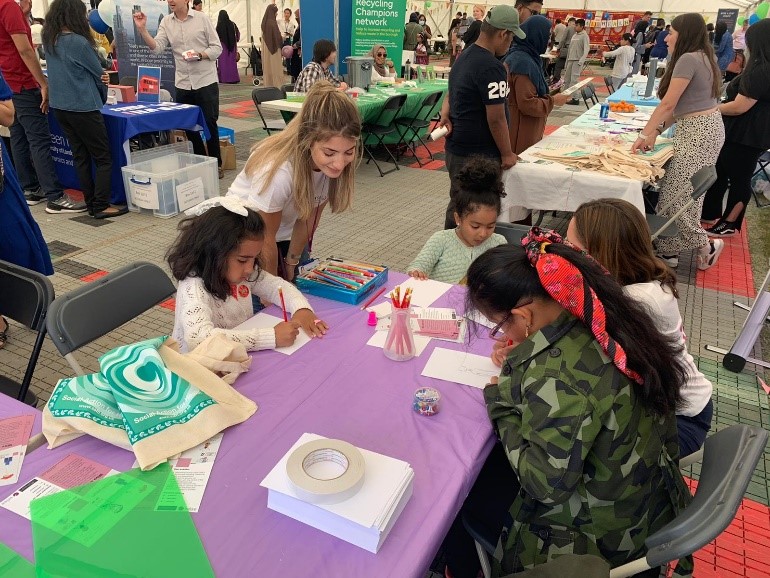 kids doing the Draw yourself as a scientist activity at the WISE stall during the 2022 Festival of Communities