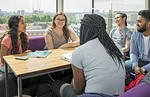 Queen Mary students in discussion around a table