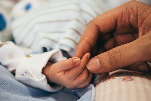 A photo of a mother holding a newborn baby