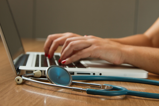 healthcare professional working on a computer