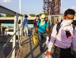 Indian migrant workers return home at a railway station during the national coronavirus lockdown