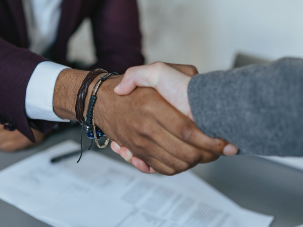 A photograph of two people shaking hands