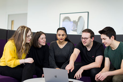 Undergraduate law students at Queen Mary sitting in the graduate centre looking at a laptop