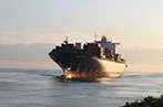 A shipping container going across the ocean.