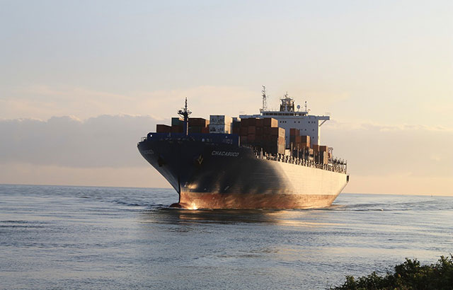 A shipping container going across the ocean.