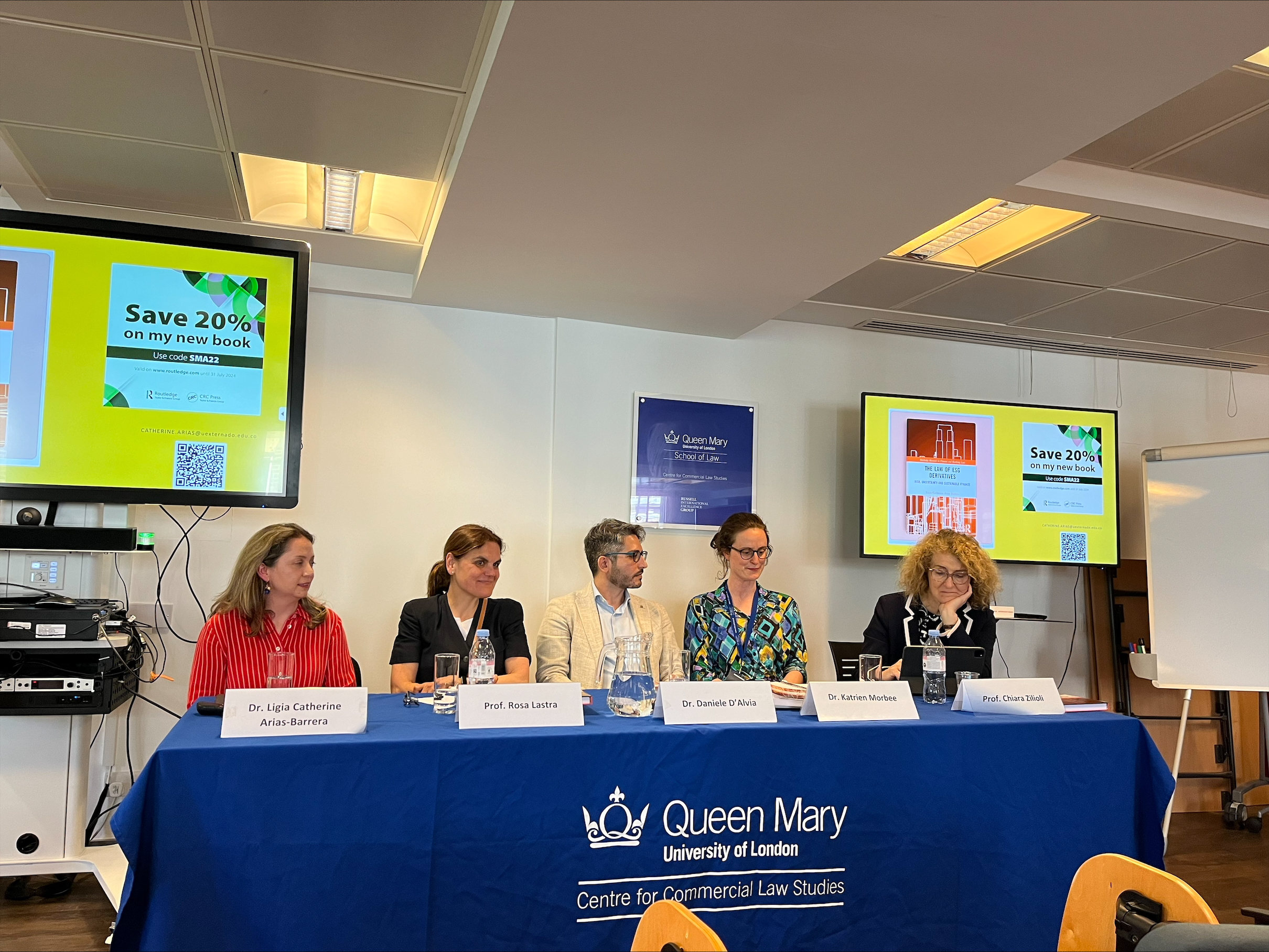 5 speakers sitting on a panel table