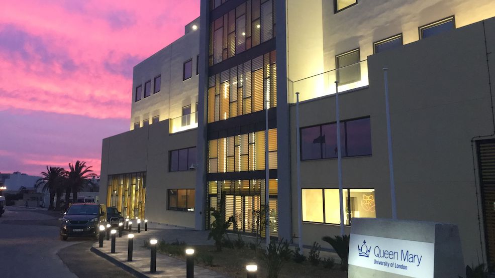 The exterior of Queen Mary Malta's main building at sunset