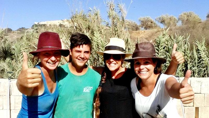 A group of four volunteers smile for the camera