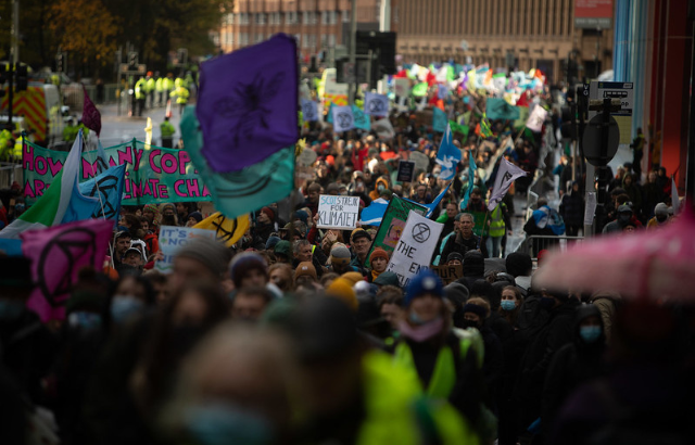 Climate activists bring the message Insure Our Future to COP26 in Glasgow, Scotland, UK, on 6th Nov 2021_Credit: Jeremy Sutton-Hibbert