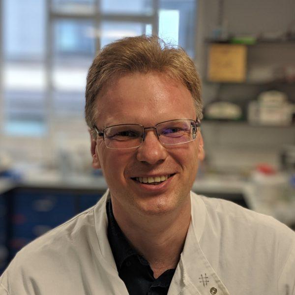 Andres Braun smiling in lab