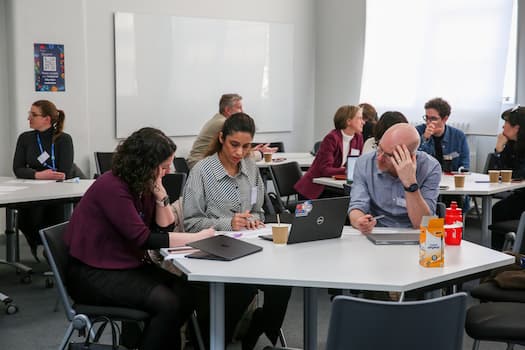 People sat around tables in a room