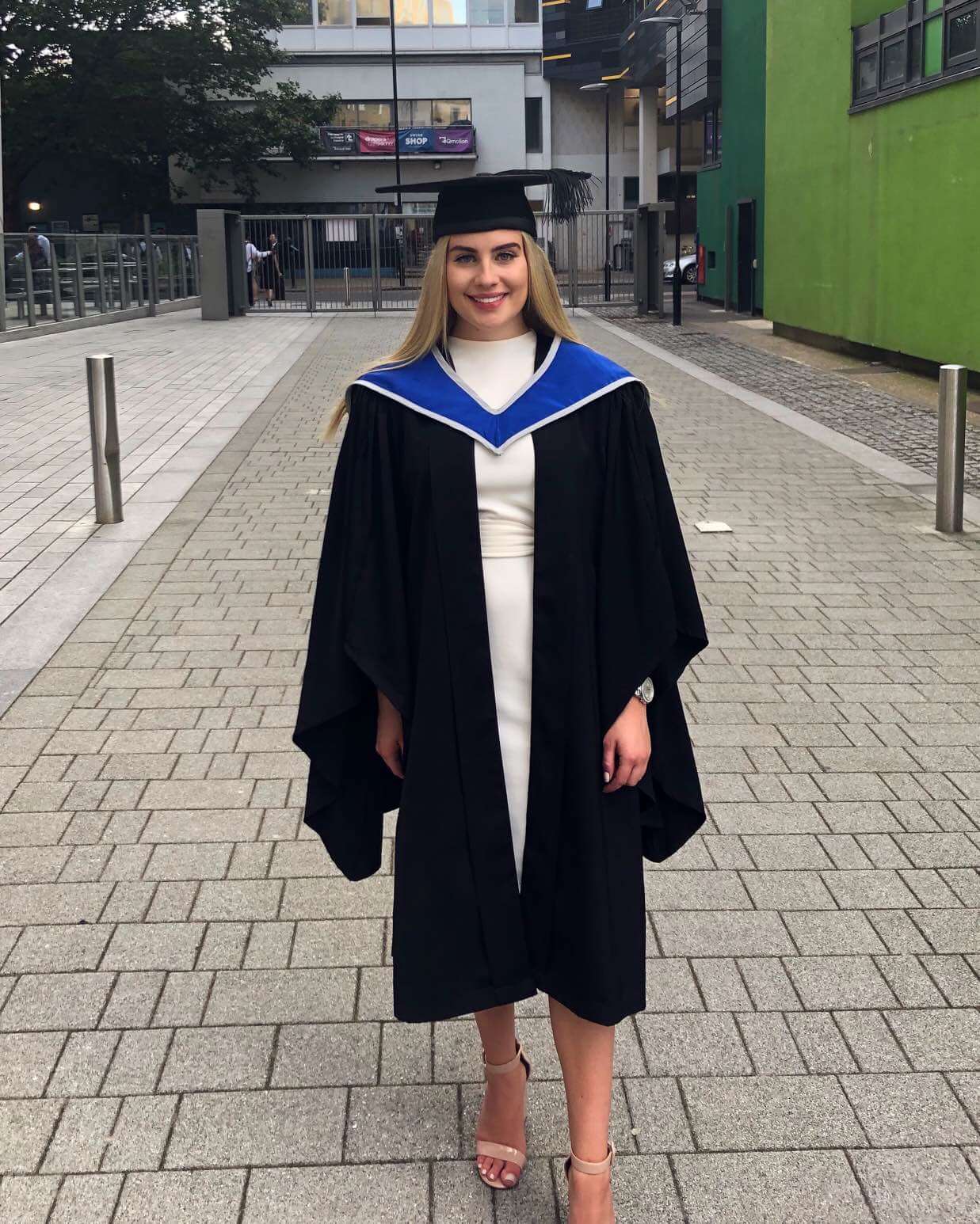 Alumna Hayley McCloskey dressed in her graduation cap and gown.