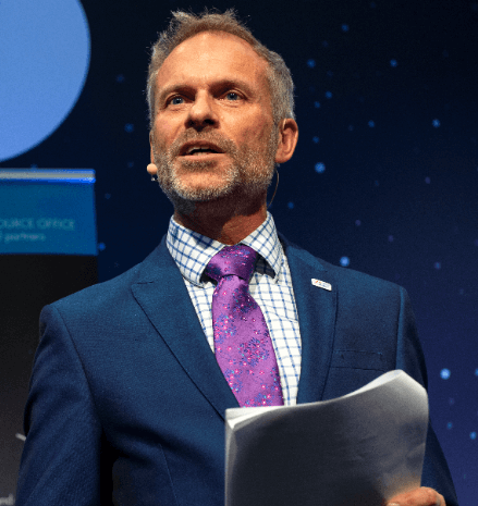 Headshot of alumnus Jeremy Curtis talking at a space conference