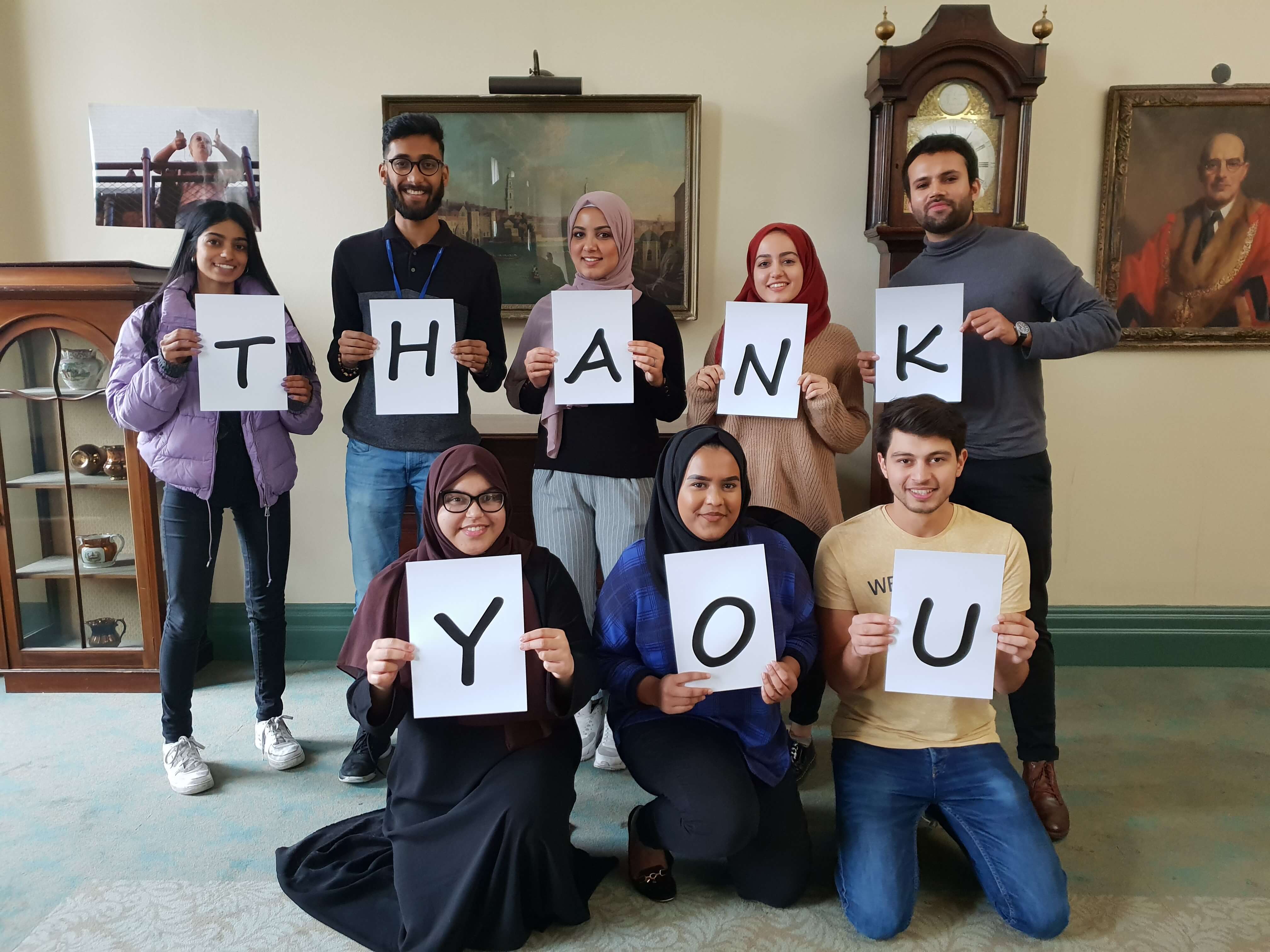 Student callers holding thank you sign