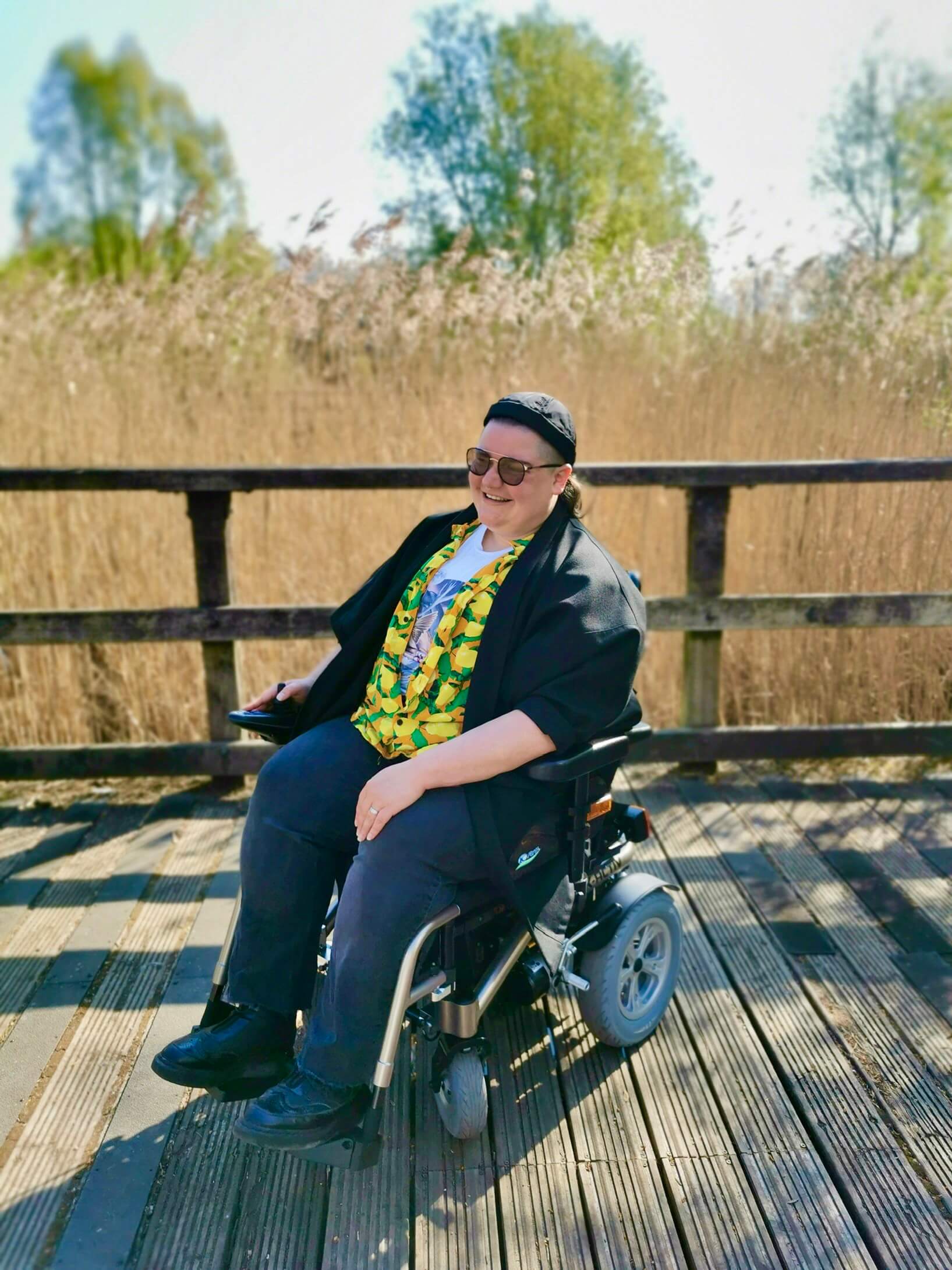 Alumnus Wilson Young sitting down in a country setting.