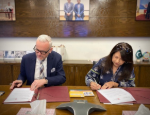 Professor Stefan Krummaker signing memorandum of understanding with Maheen Gauri from IBA Karachi