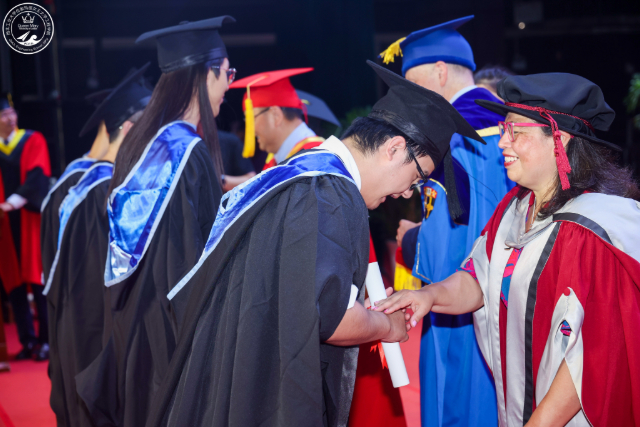 Principal Colin Bailey and Dr Maria Romero-Gonzalez congratulate 2024 NPU graduates