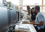 Image of students sitting in front of computes in a lab