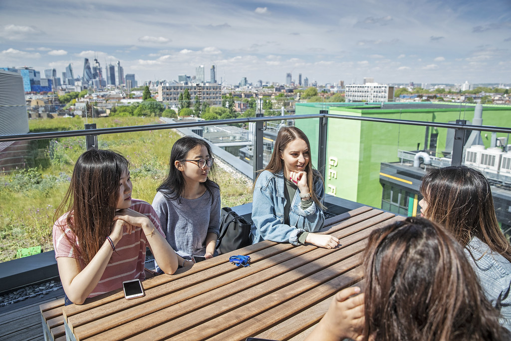 Queen Mary undergrads sitting at a bench