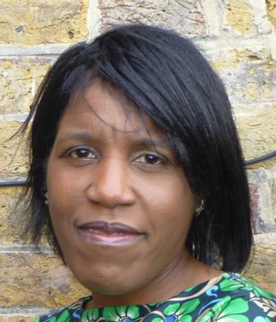 Portrait photo of Dr Vanessa Muirhead in front of brick wall