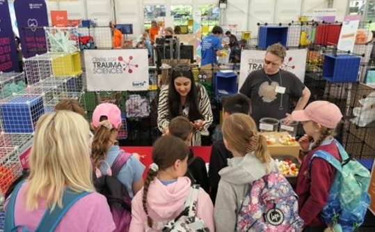 Two volunteers run an activity with a group of young people