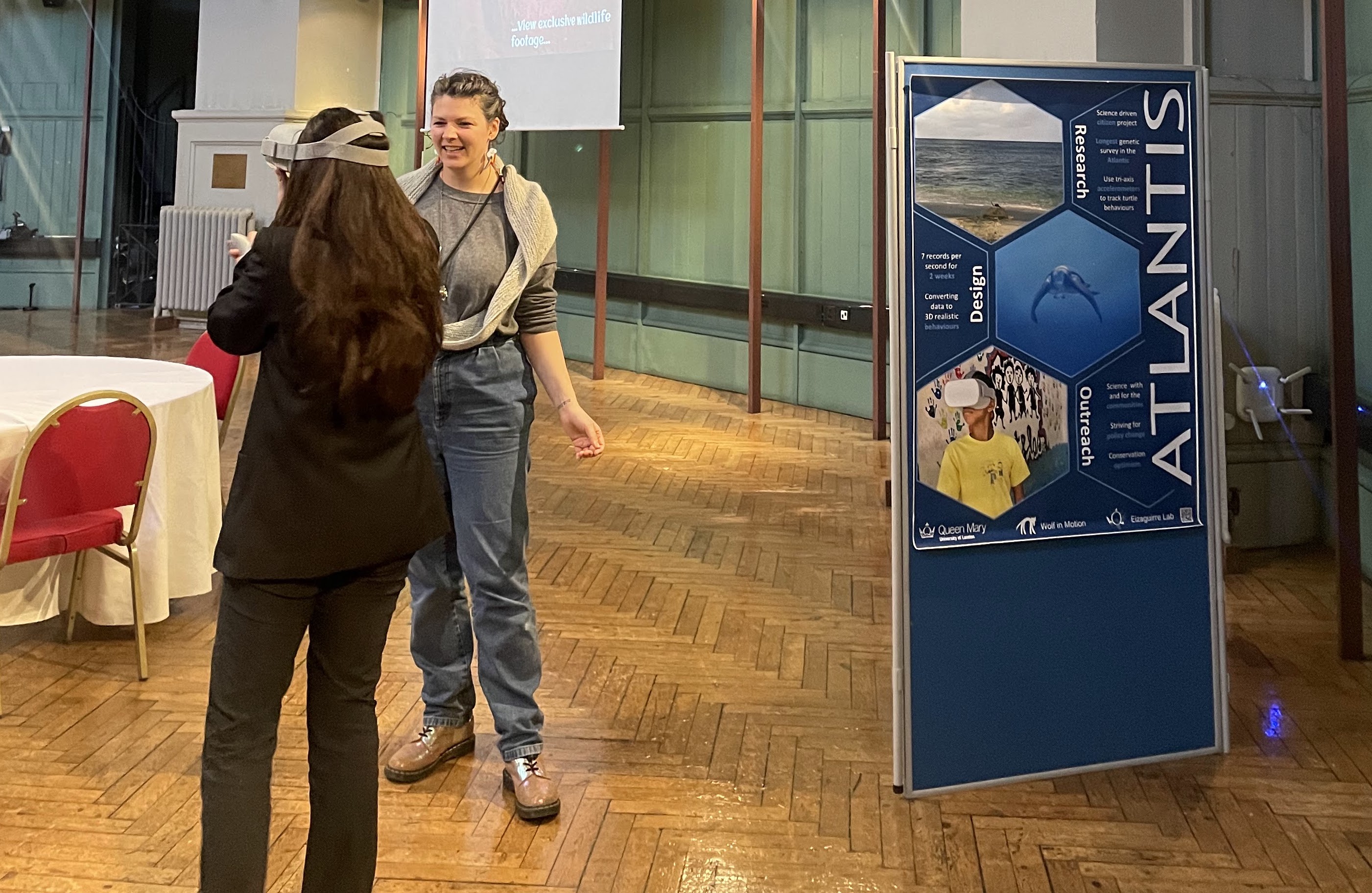 A student wearing a VR headset engaging with a researcher.