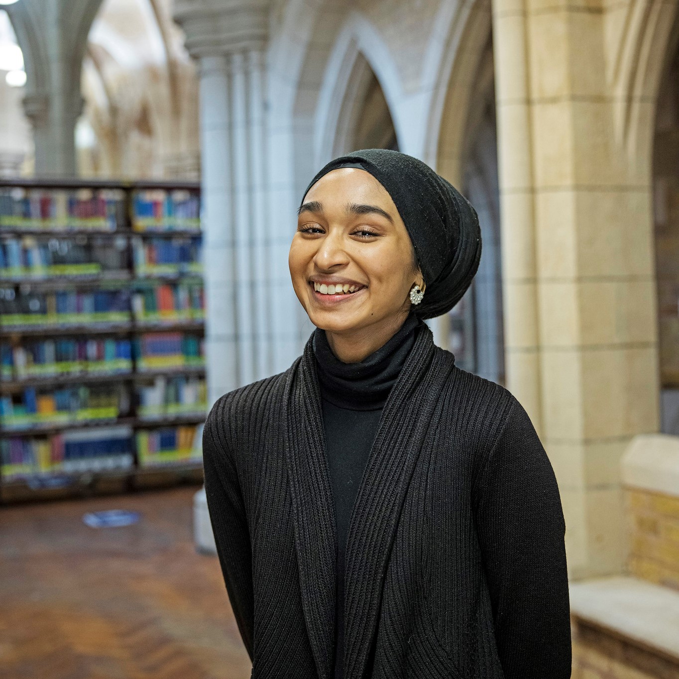 Student smiling in library